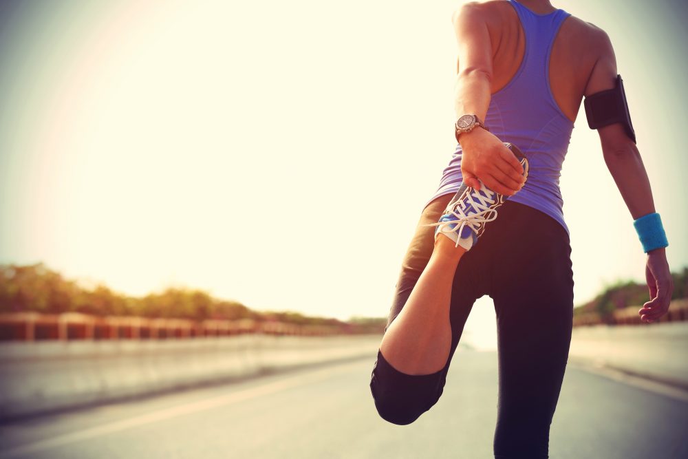 A woman stretching after using guelph chiropractic to live a healthy lifestyle.