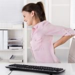 Woman experiences the problem with ergonomic office chairs
